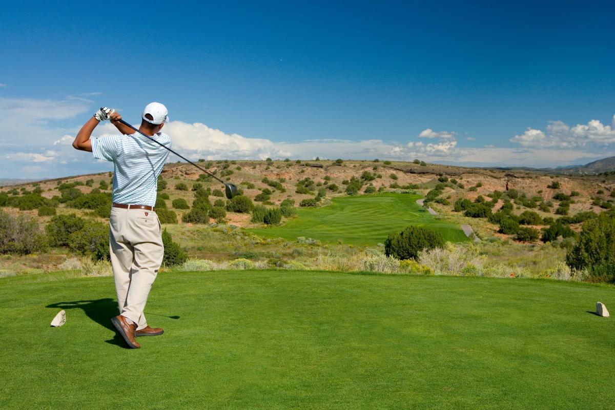 Golfer teeing off